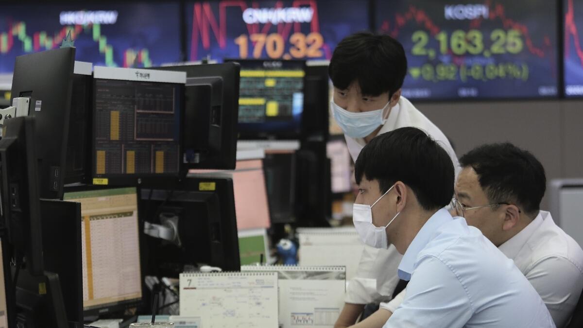 Currency traders watch monitors at the foreign exchange dealing room of the KEB Hana Bank headquarters in Seoul, South Korea, on Wednesday. - AP