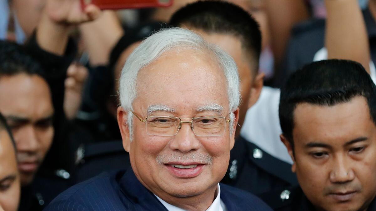 Former Malaysian prime minister Najib Razak gets into a car after his court appearance at the Kuala Lumpur High Court in Kuala Lumpur, Malaysia. AP file