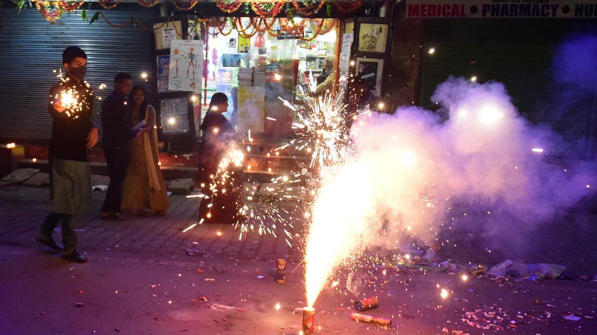 People light firecrackers during Diwali in Allahabad. AFP