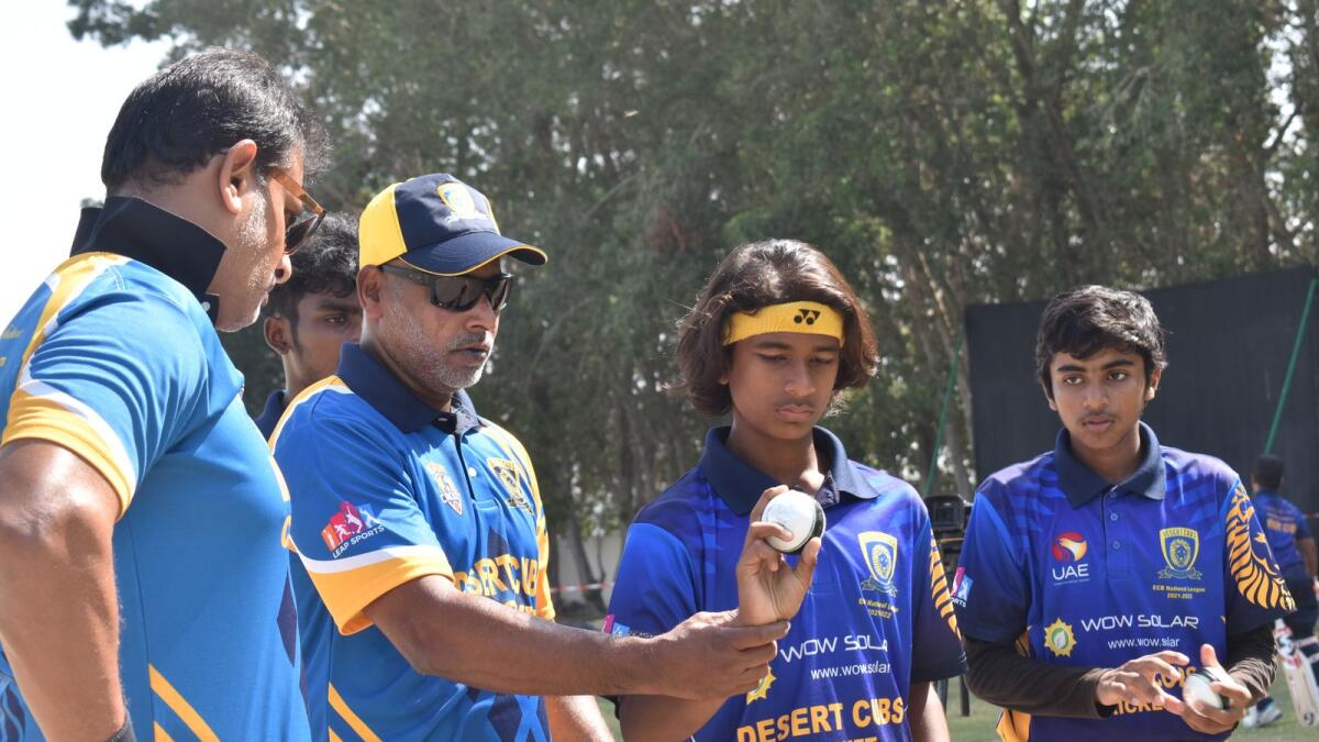 Chaminda Vaas shows the correct wrist position to young pace bowlers of the Desert Cubs Sports Academy at the Sharjah English School. (Picture courtesy Desert Cubs Sports Academy)