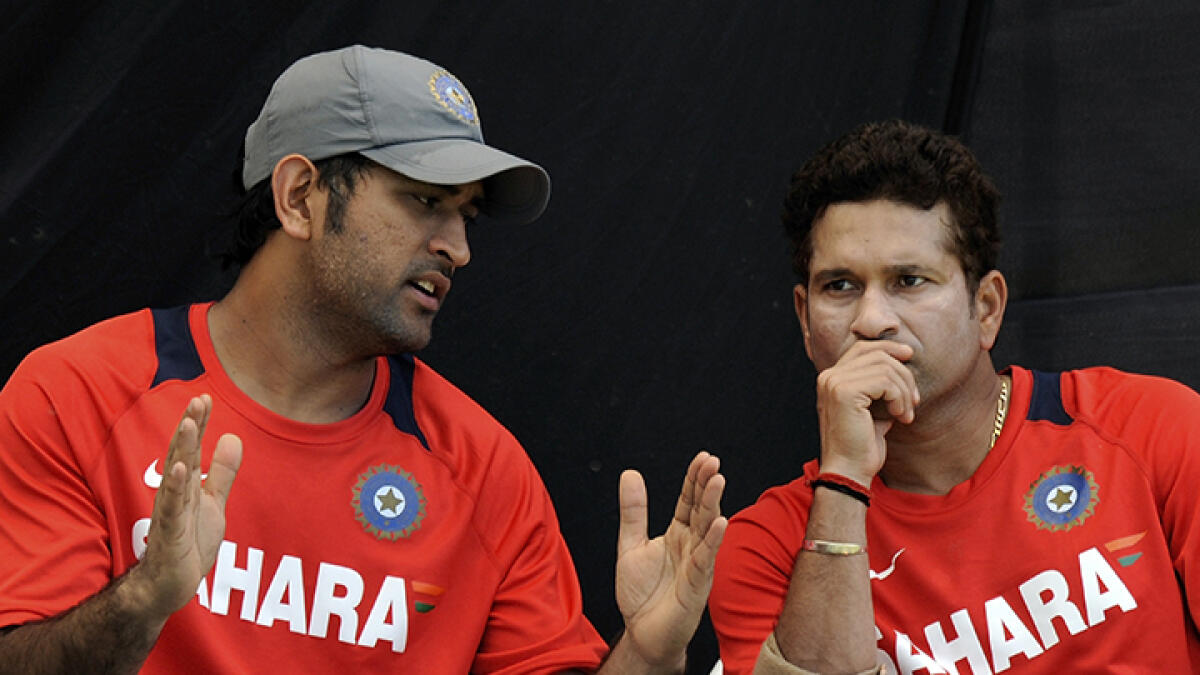 Sachin Tendulkar and M.S.Dhoni share a moment during the 2011 Cricket World Cup. -- AFP file