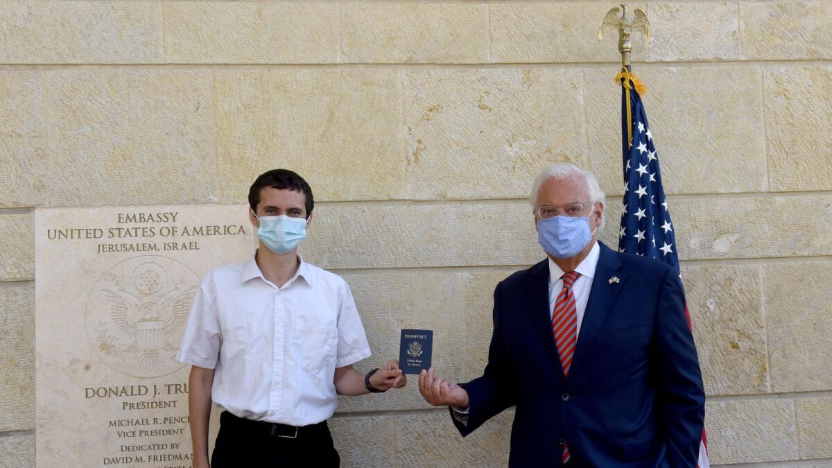 US Ambassador to Israel David Friedman presents Menachem Zivotofsky, a US citizen who was born in Jerusalem, his passport that lists Israel as birthplace at the US Embassy in Jerusalem on Friday.