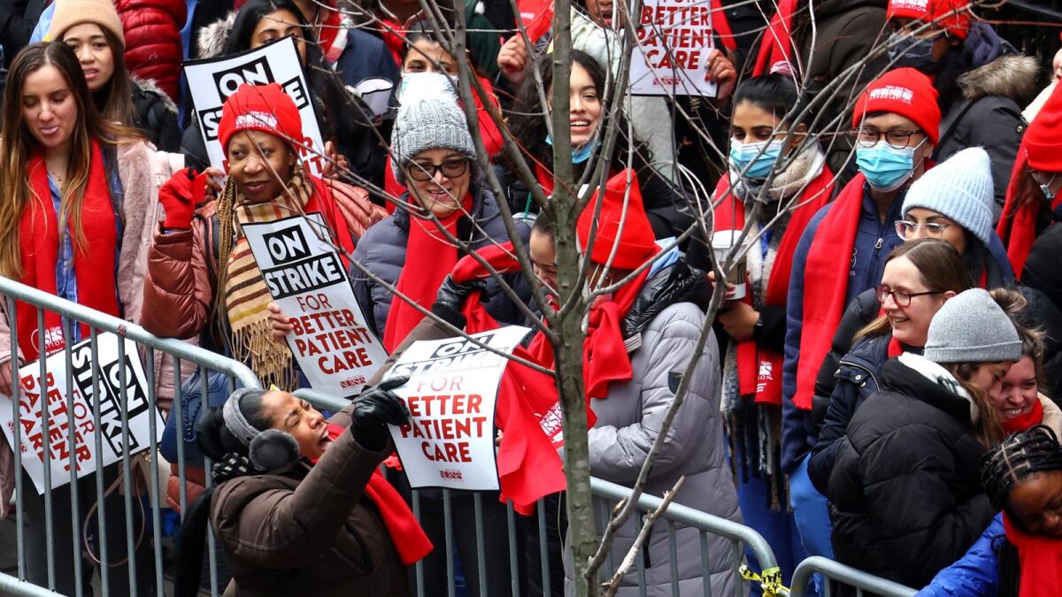 A person leads chants as striking union nurses from the New York State Nurses Association walk the picket line outside Montefiore Hospital in the Bronx borough of New York City on Monday. — Reuters