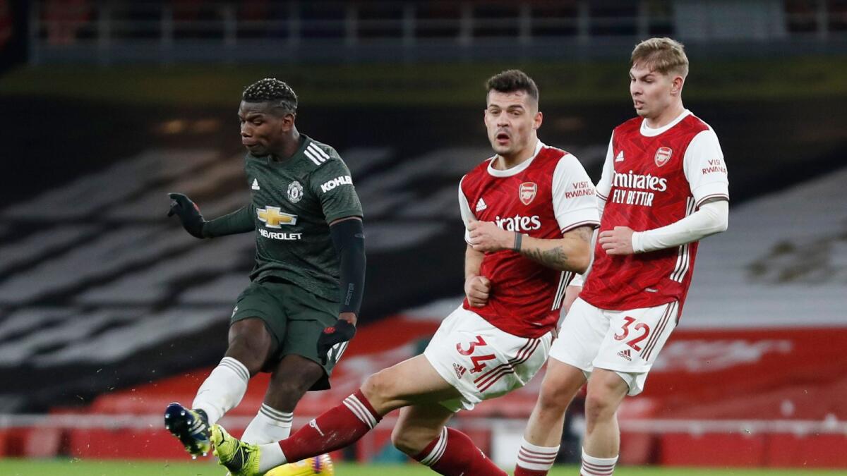 Manchester United's Paul Pogba in action against Arsenal's Granit Xhaka and Emile Smith. — Reuters