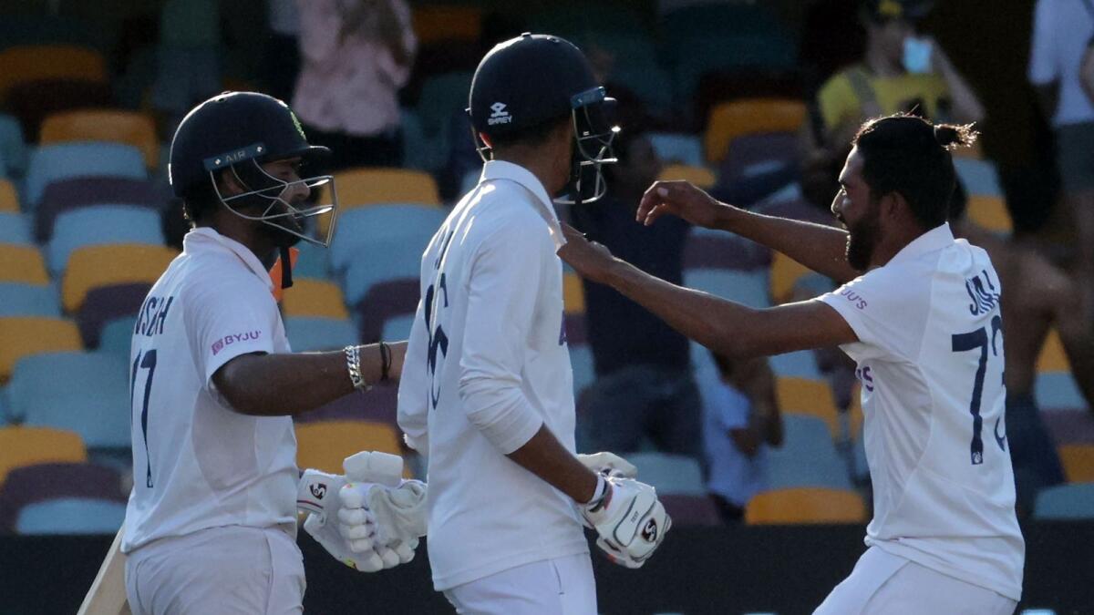 India's paceman Mohammed Siraj runs to join victory celebrations with teammates Rishabh Pantat and Navdeep Saini at the end of the fourth cricket Test match at The Gabba in Brisbane.