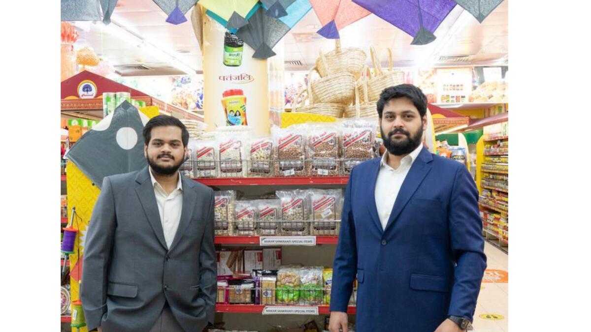 Hrishikesh and Rohit Datar, directors at Al Adil Trading with the Makar Sankranti products display.