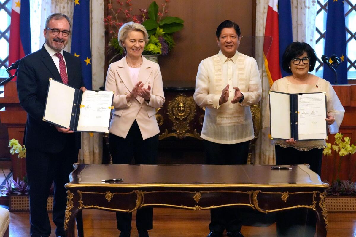Philippine President Ferdinand Marcos Jr. claps beside European Commission President Ursula von der Leyen after signing ceremonies at the Malacanang Presidential Palace in Manila, Philippines, on Monday. -- AP