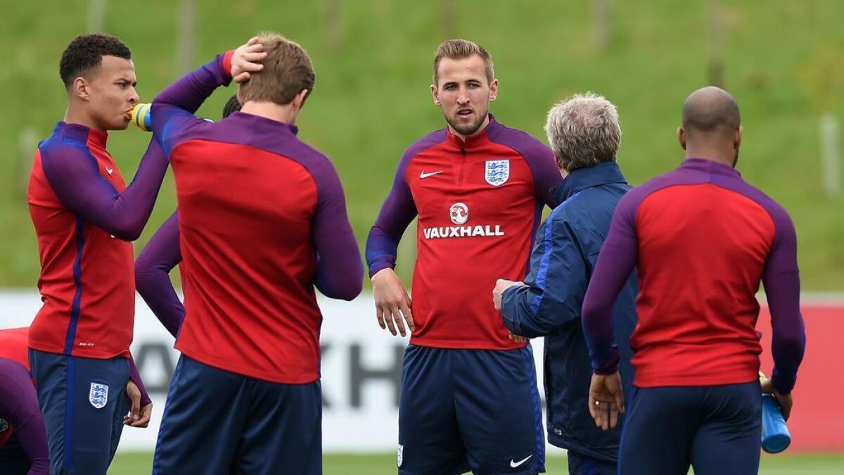 England's striker Harry Kane (third right) interacts with his teammates during a team training session.