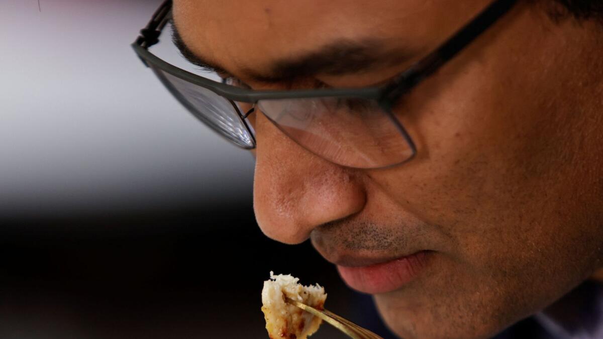 Founder &amp; CEO Uma Valeti takes in the aroma of a cooked piece of cultivated chicken breast created at the UPSIDE Foods plant, where lab-grown meat is cultivated, in Emeryville California. — Reuters