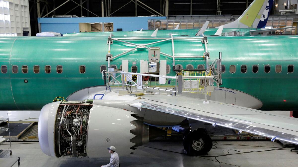 A worker walks past Boeing's new 737 MAX-9 under construction at their production facility in Renton, Washington. — Reuters file