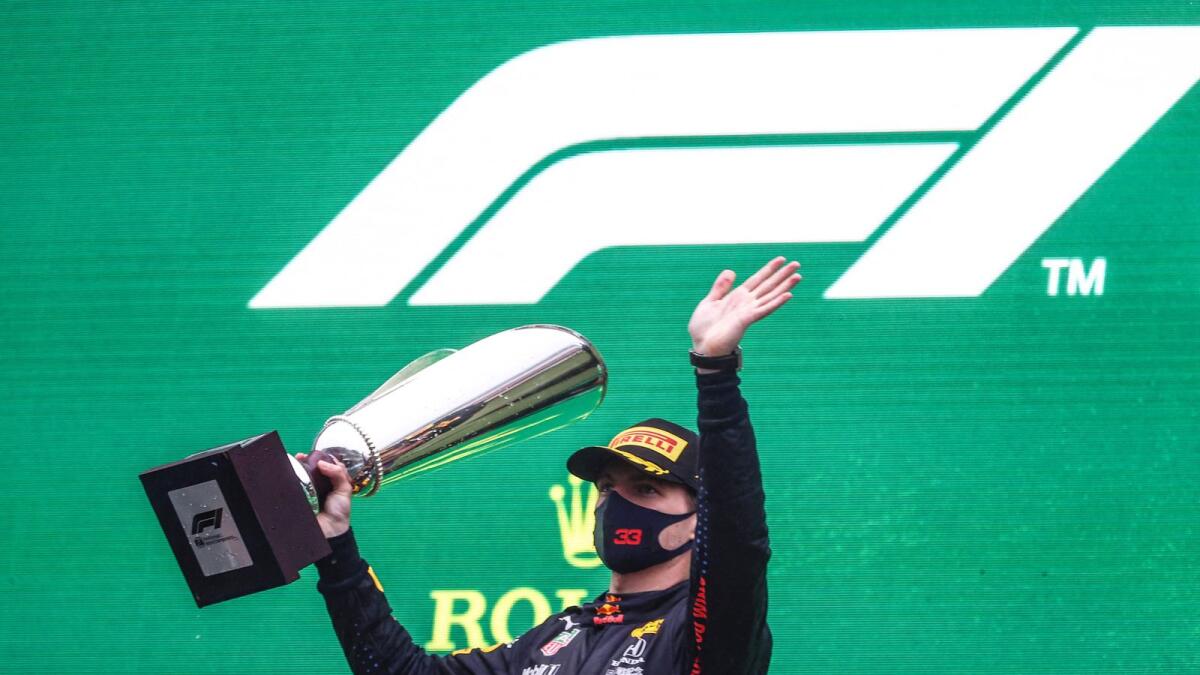 Red Bull's Dutch driver Max Verstappen celebrates with his trophy on the podium after winning the Formula One Belgian Grand Prix. — AFP