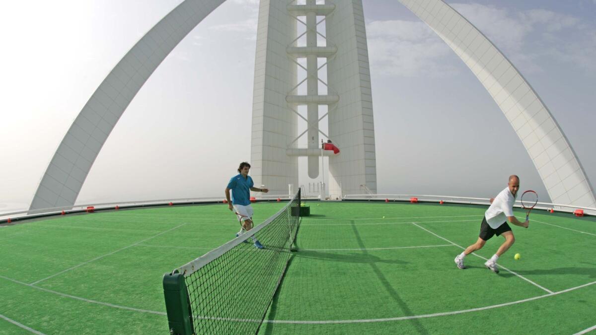 Roger Federer (left) plays Andre Agassi on the helipad of the Burj Al Arab in 2005. (AFP)