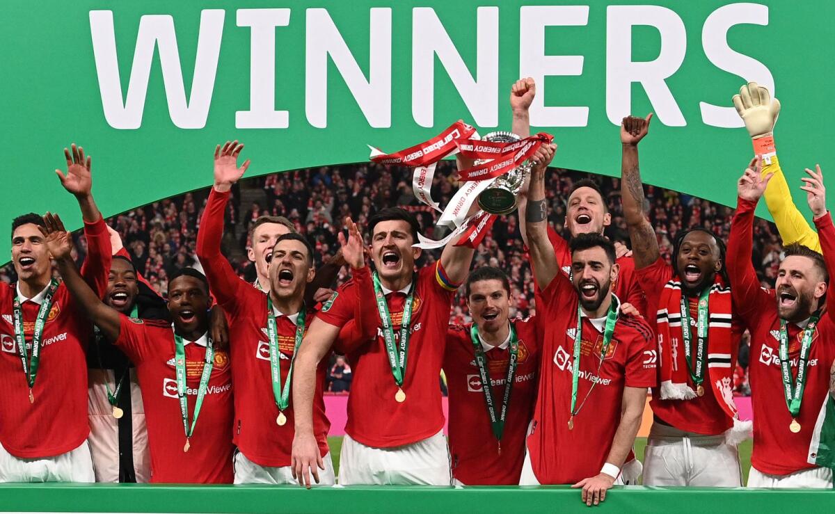 Manchester United players celebrate winning the trophy at Wembley on Sunday. — AFP