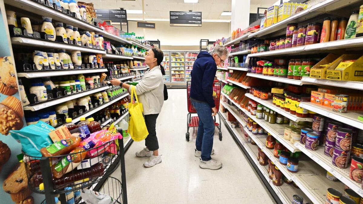 People shop in the food section of a retail store in Rosemead, California.   Consumer inflation posted a surprise acceleration in February, US Labour Department data showed on Tuesday, a development that could give policymakers pause as they mull the right time to start interest rate cuts. — AFP