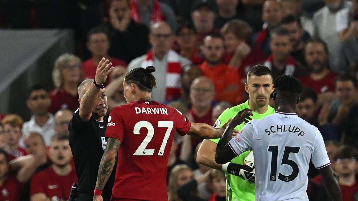 Liverpool's Darwin Nunez (27) is sent off by referee Paul Tierney. (AFP)