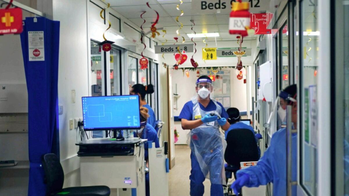 Medical staff wearing PPE,  on a ward for Covid-19 patients at King's College Hospital, in south east London. — AP