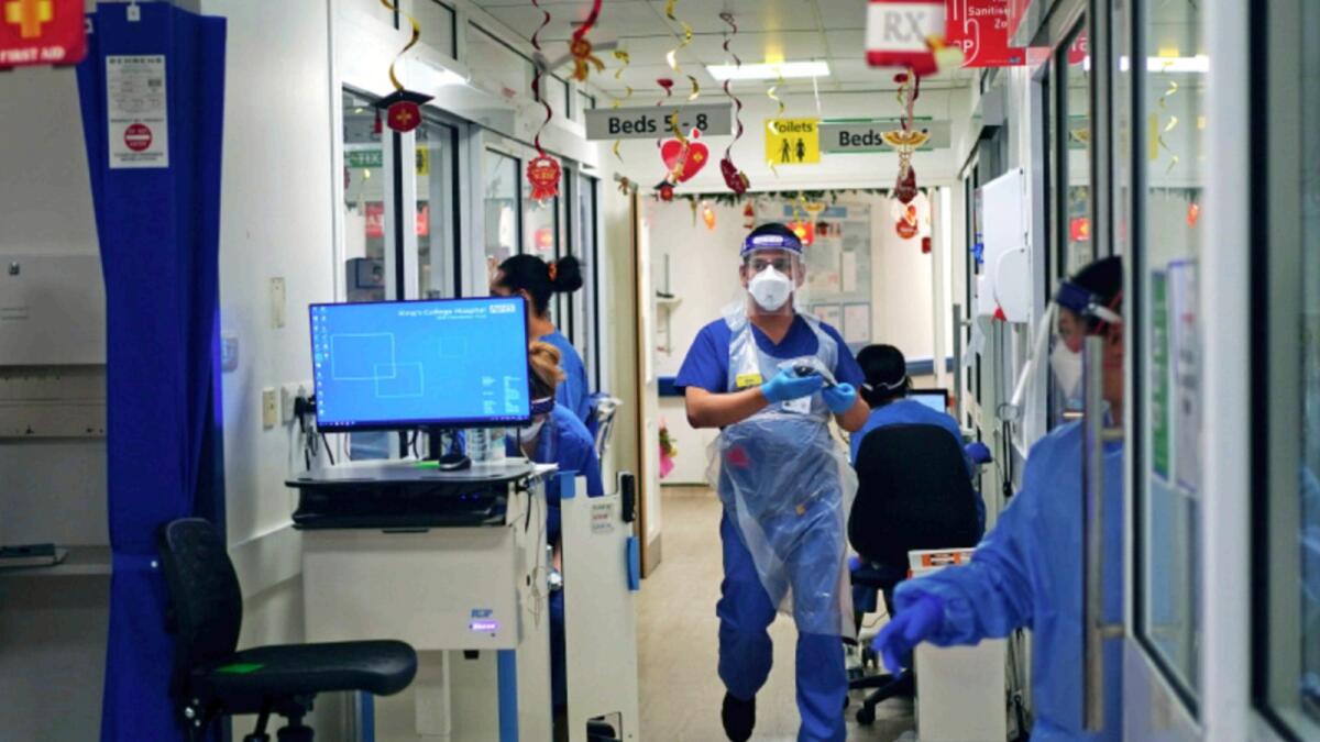 Medical staff wearing PPE,  on a ward for Covid-19 patients at King's College Hospital, in south east London. — AP