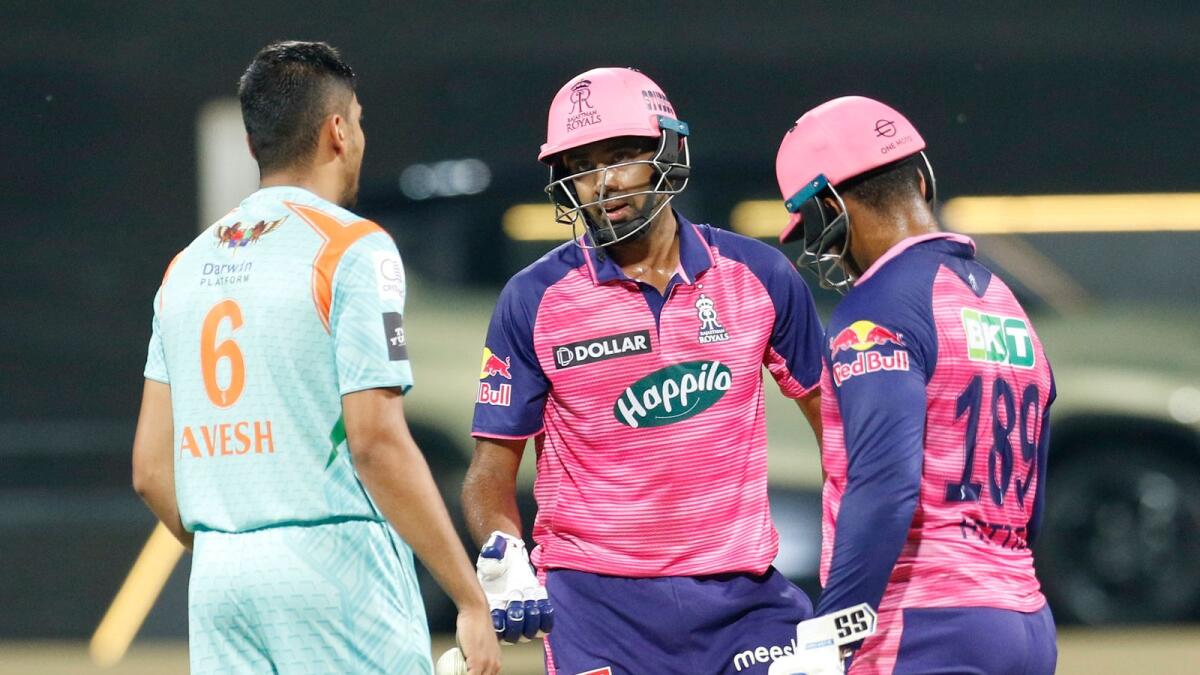 Ravichandran Ashwin of Rajasthan Royals talks with Avesh Khan of Lucknow Super Giants during the IPL match on Sunday. (BCCI)