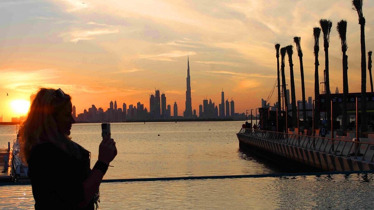 A lady taking picture of the Dubai skyline from the upcoming Dubai Creek Harbour. (KT photo by Juidin Bernarrd)