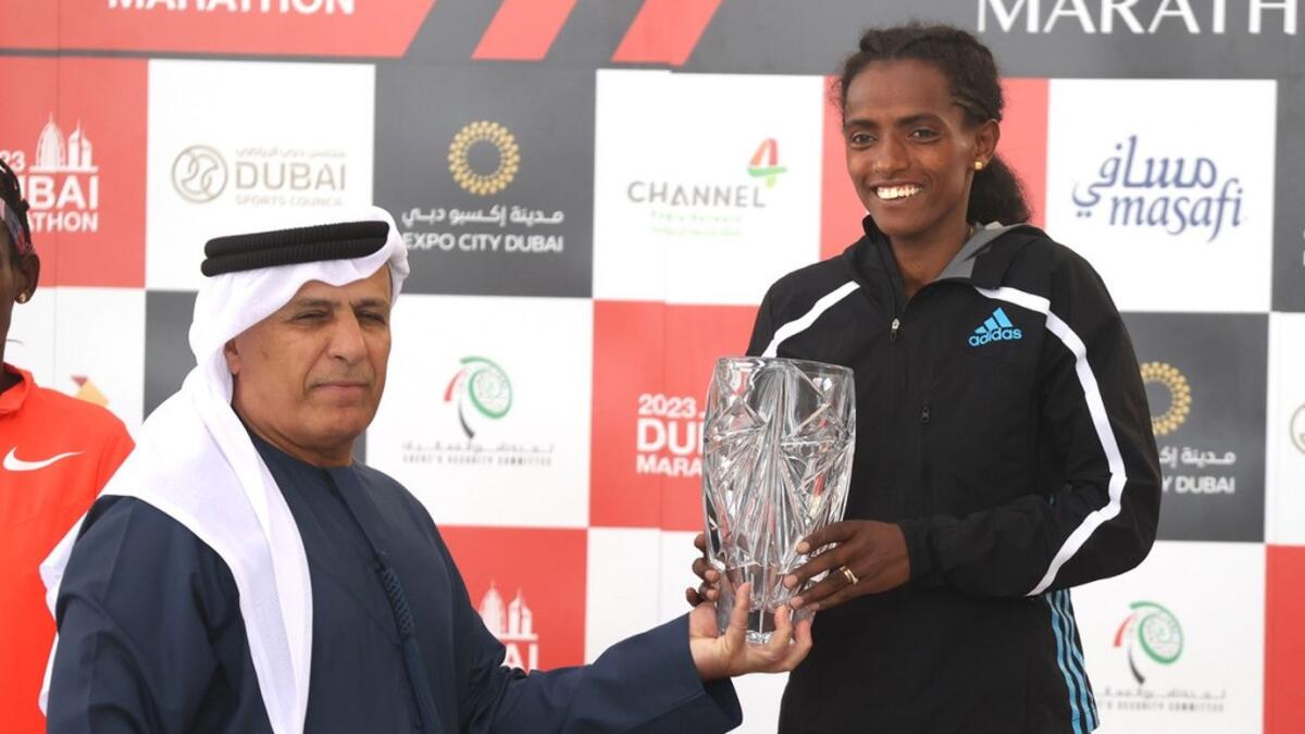Dera Dida, receives her Dubai Marathon winner’s trophy from Mattar Al Tayer, Deputy Chairman of the Dubai Sports Council. - Supplied Photo