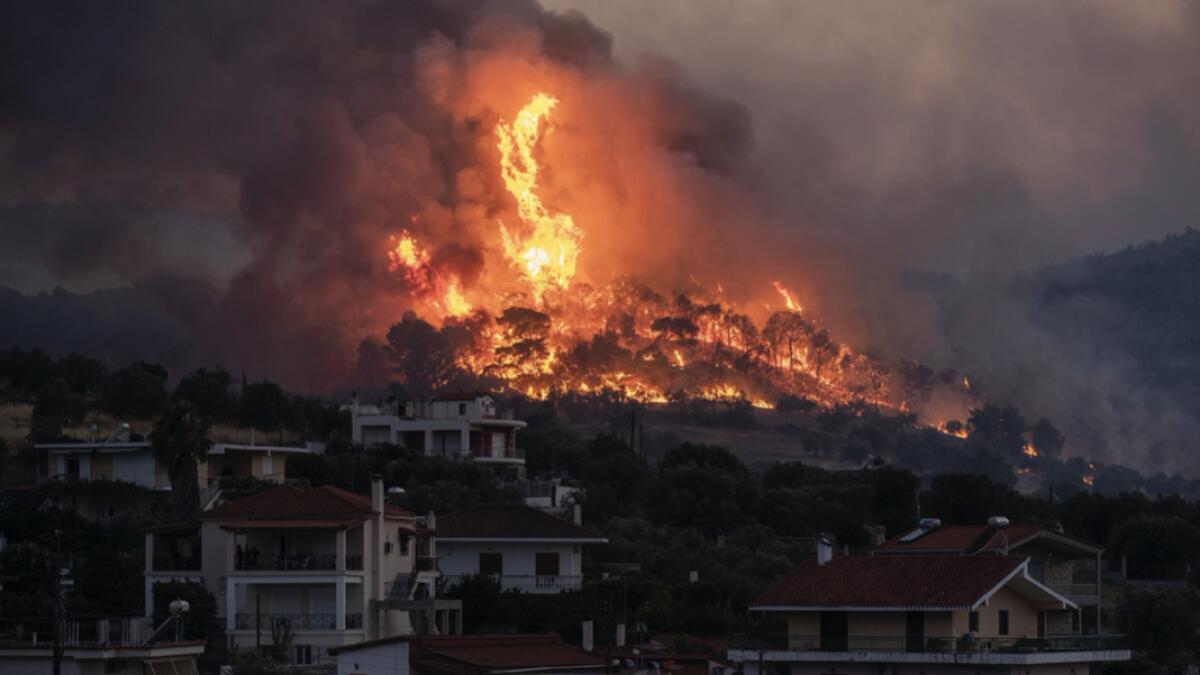 Fire burns near the village of Galataki as authorities evacuate the place near Corinth, Greece. More than 250 firefighters, backed by water-dropping aircraft, were struggling Wednesday to contain a large wildfire fanned by strong winds that has forced the evacuation of five settlements in southern Greece. Photo: AP