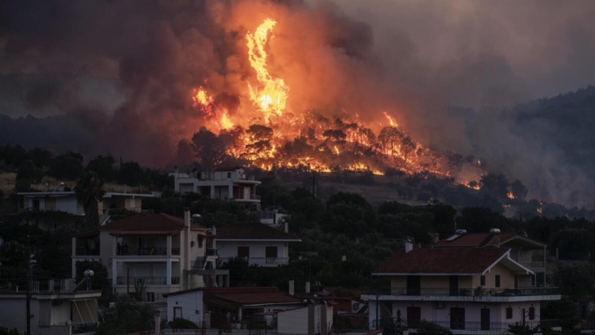 Fire burns near the village of Galataki as authorities evacuate the place near Corinth, Greece. More than 250 firefighters, backed by water-dropping aircraft, were struggling Wednesday to contain a large wildfire fanned by strong winds that has forced the evacuation of five settlements in southern Greece. Photo: AP