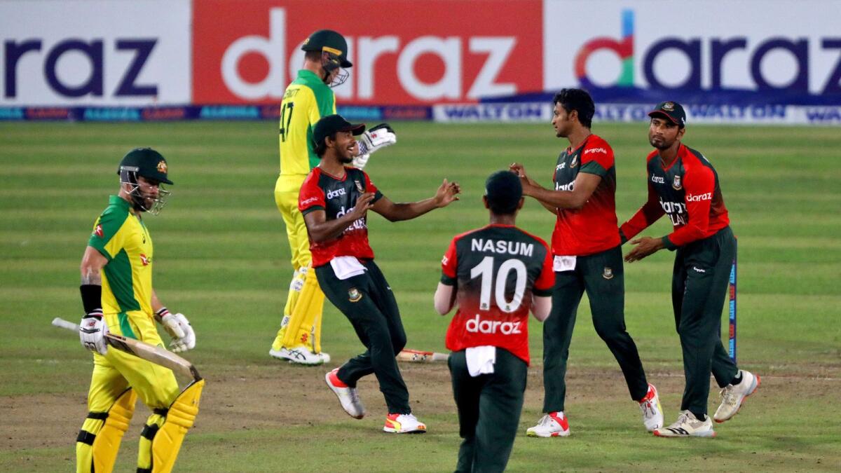 Bangladesh's Shakib Al Hasan celebrates with his teammates after taking the wicket of Australia's captain Matthew Wade. — Reuters