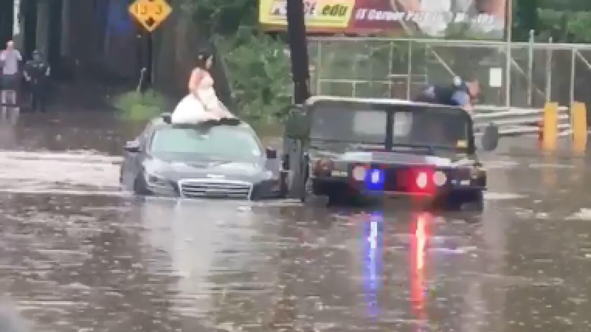 Video: Bride stuck in rising floodwaters on wedding day