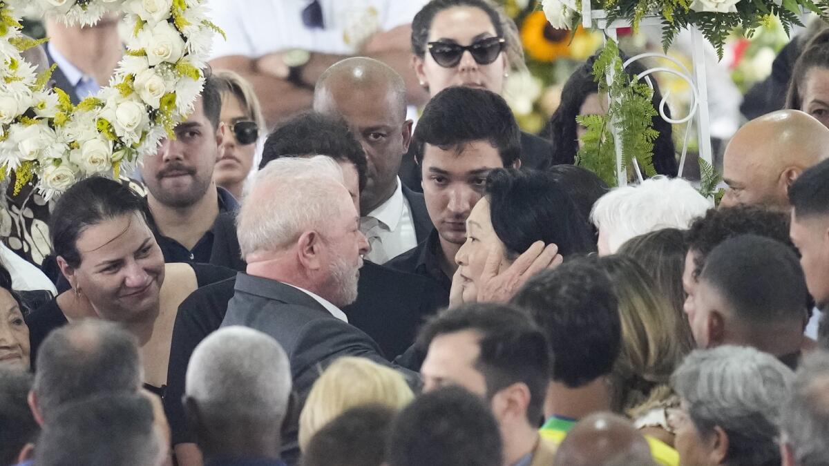 Brazil President Luiz Inacio Lula da Silva, gives condolences to Marcia Aoki, widow of the late Brazilian soccer player Pele.