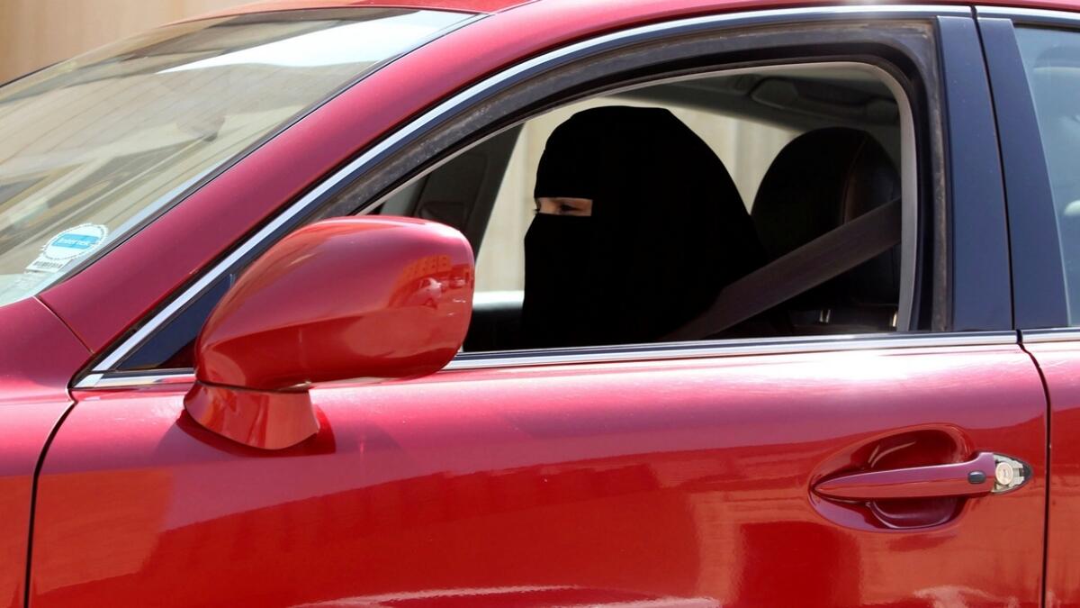 A woman drives a car in Riyadh, Saudi Arabia.- Reuters