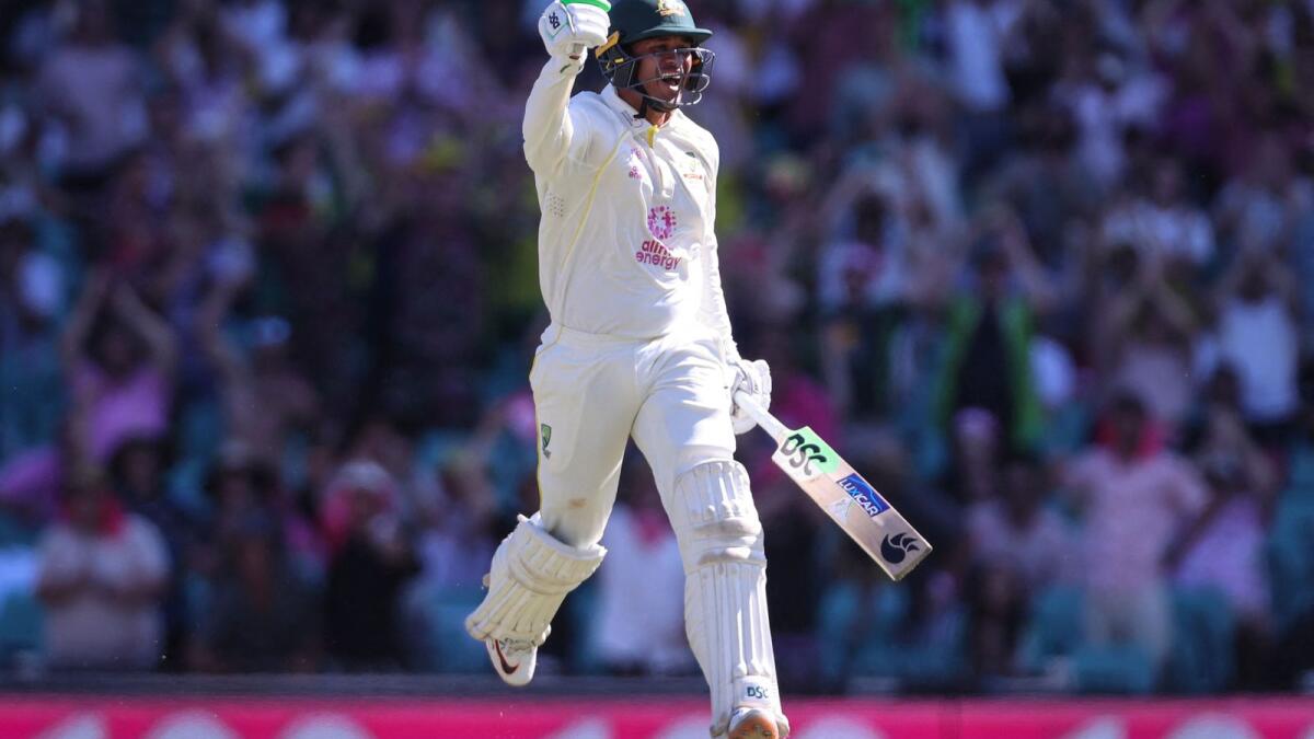 Australia's Usman Khawaja celebrates after reaching his century on Saturday. — AFP