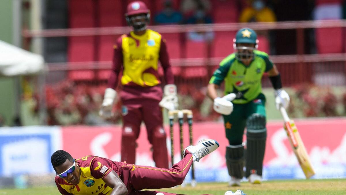 Akeal Hosein (left) of the West Indies attempts to stop Babar Azam (right) of Pakistan from scoring during the 3rd T20I match at Guyana National Stadium in Providence, Guyana. — AFP