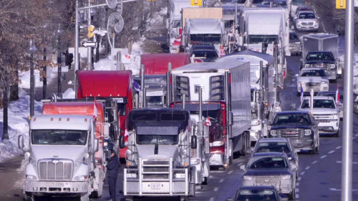 Vehicles from the protest convoy are parked blocking lanes on a road in Ottawa. — AP