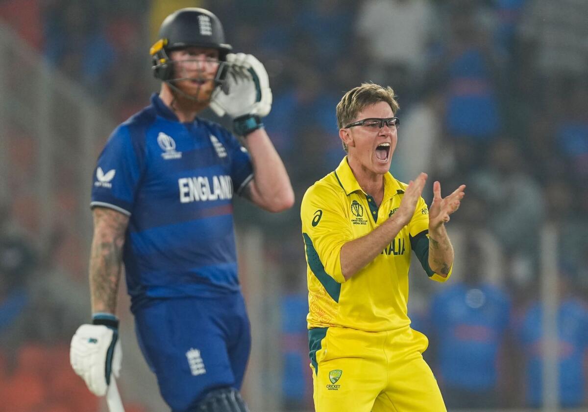 Australia's bowler Adam Zampa celebrates the wicket of England's batter Jos Buttler during the ICC Men's Cricket World Cup 2023. - PTI
