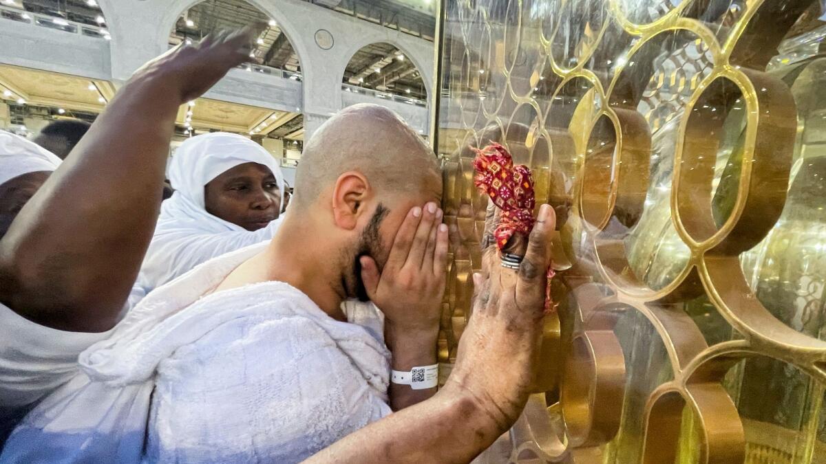 A Muslim pilgrim cries next to the Station of Ibrahim 'Maqam Ibrahim', as Saudi Arabia welcomes back pilgrims for the 2022 haj season. Photo: Reuters