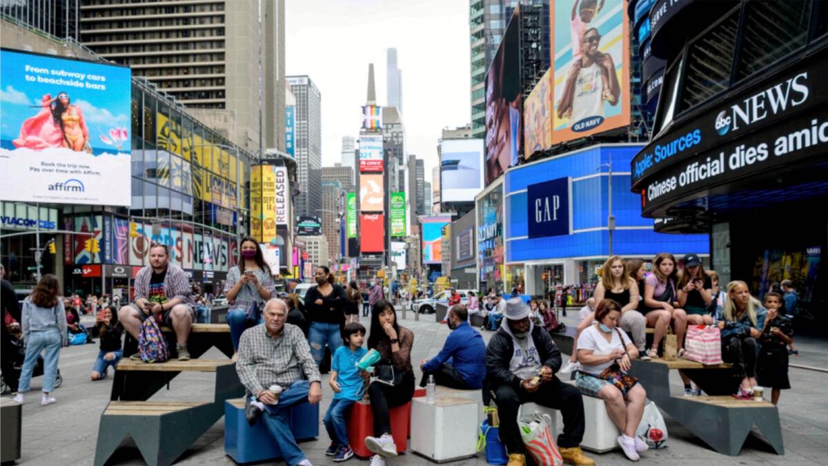 People sit in Times Square in New York City. — AFP File