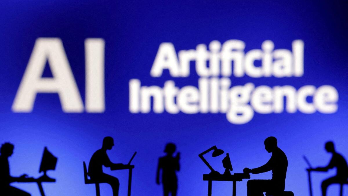Figurines with computers and smartphones are seen in front of the words 'Artificial Intelligence AI' in this illustration. — Reuters file