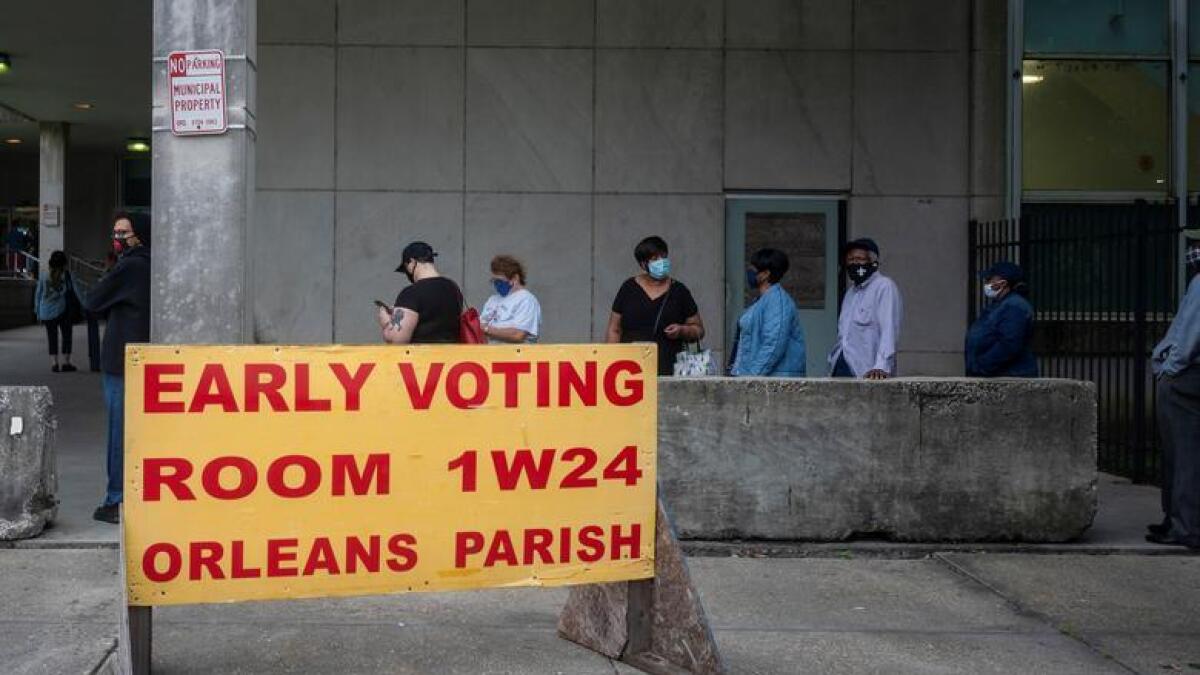 People line up to cast their ballot for the upcoming presidential election as early voting begins in New Orleans, Louisiana.
