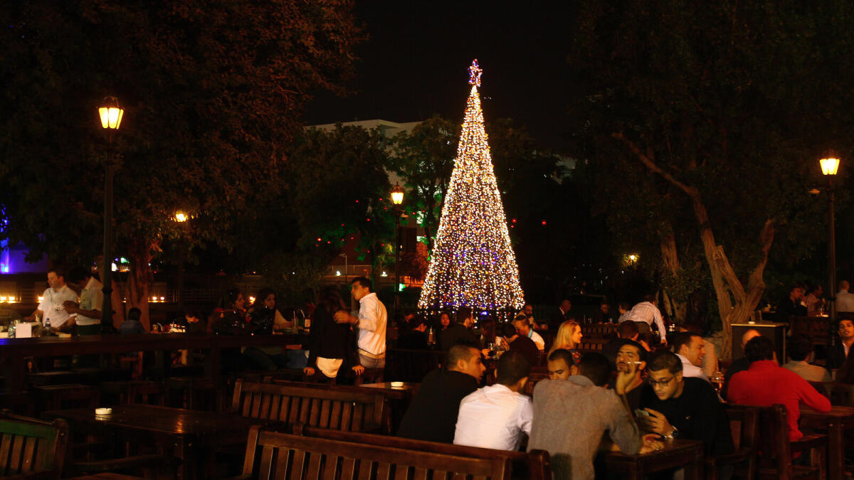 People enjoying dinner in the background of Xmas tree at  restaurants in Irish Village in Garhoud Dubai. KT photo by Shihab