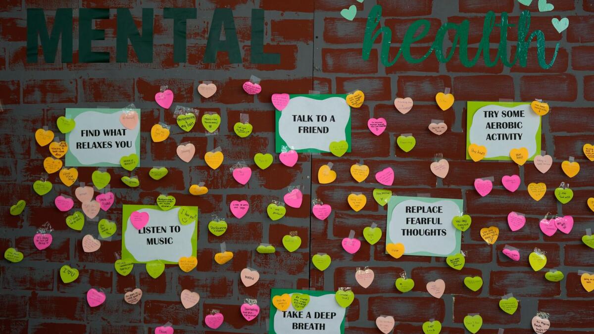 Notes from students expressing support and sharing coping strategies paper a wall, as members of the Miami Arts Studio mental health club raise awareness on World Mental Health Day, on October 10, 2023. Photo: AP