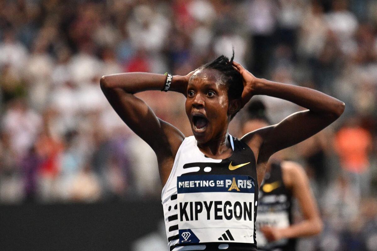 Kenya's Faith Kipyegon reacts as she breaks the World record in the women's 5000metres during the IAAF Diamond League 'Meeting de Paris' at the Charlety Stadium in Paris on June 9. - AFP