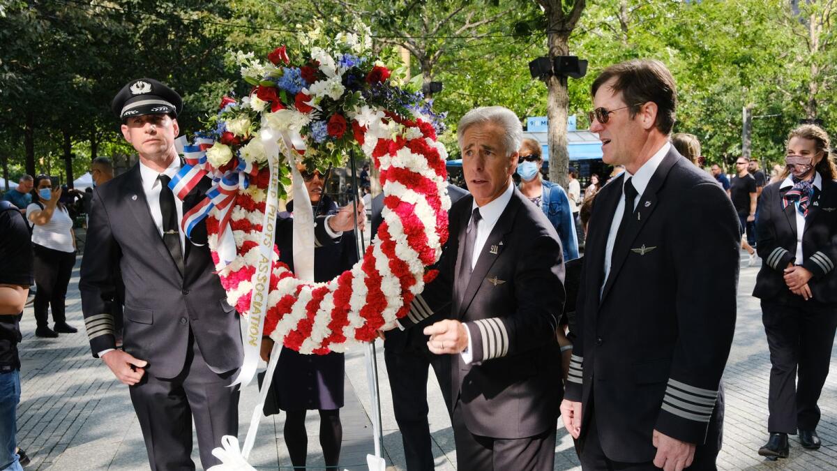 Pilots and airline workers from both United and American Airlines participate in a wreath laying ceremony for their colleagues who were killed on September 11 at the September 11th Memorial in New York City. Photo: AFP