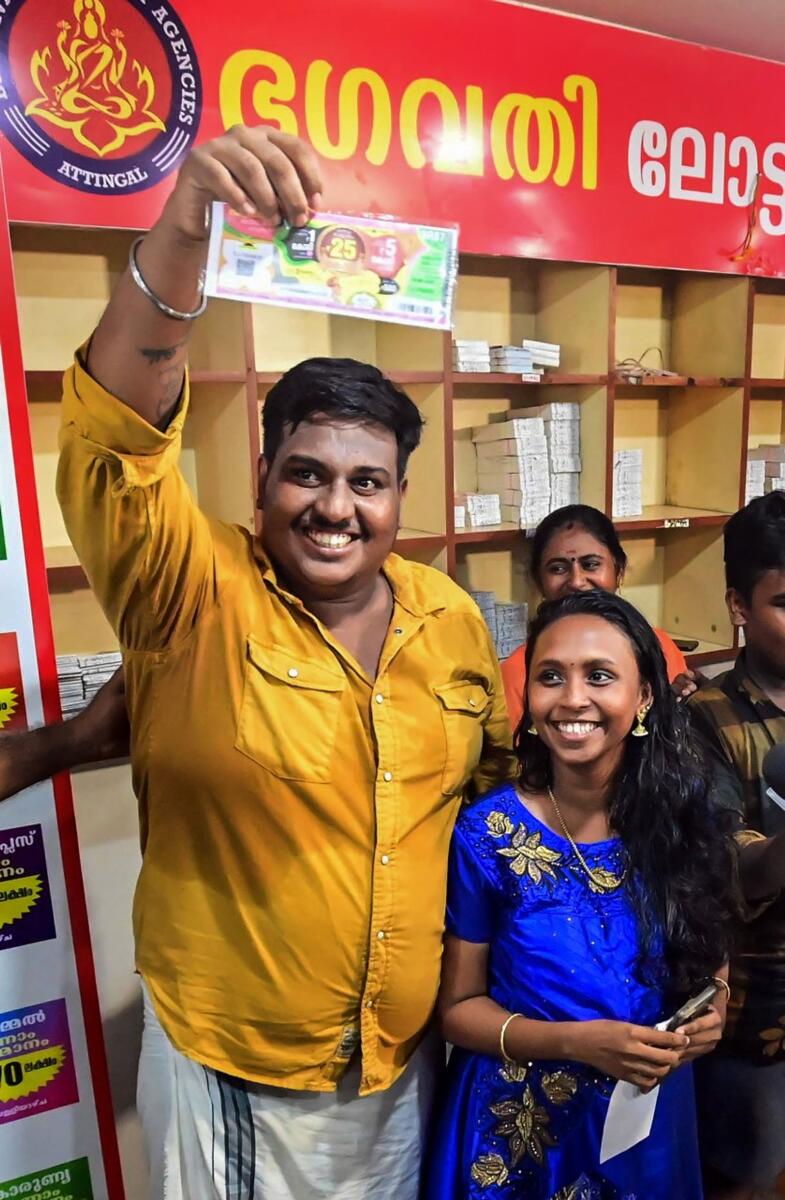 Anoop celebrates with his family members after winning the grand prize in the Onam Bumper lottery in Thiruvananthapuram on Sunday. Photo: PTI