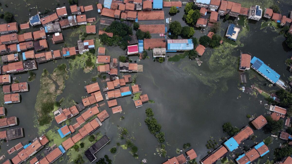 An aerial view shows flooded residential buildings due to rising water levels of the Yangtze river in Jiujiang, China's central Jiangxi province. Vast swathes of China have been inundated by the worst flooding in decades along the Yangtze River, with residents piling into boats and makeshift rafts to escape a deluge that has collapsed flood defences and turned homes into waterways.Photo: AFP