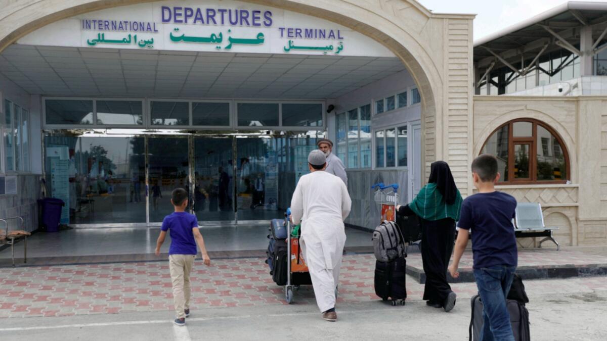 Passengers enter the departures terminal of Hamid Karzai International Airport in Kabul on Saturday. — AP