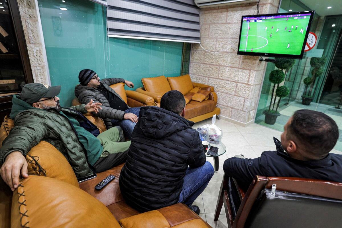 Palestinians watch the match. — AFP