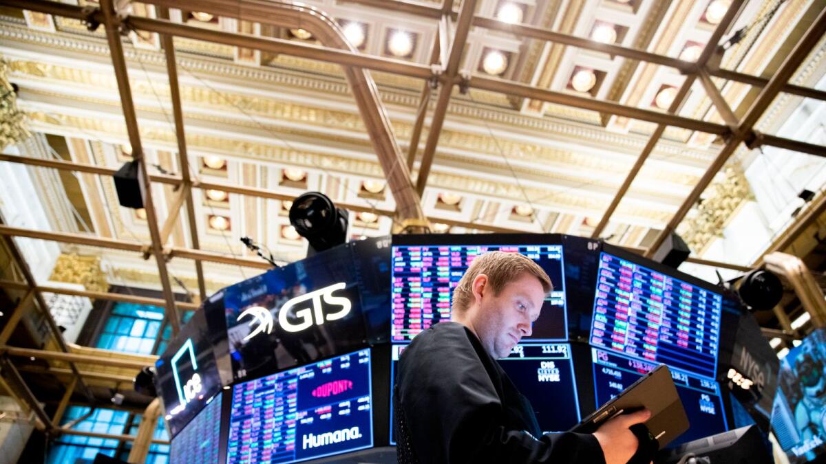 Traders work on the floor of the New York Stock Exchange. — AP
