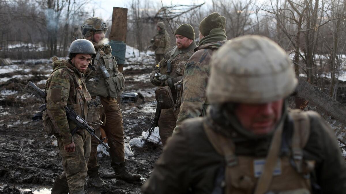 Servicemen of the Ukrainian Military Forces gather after fighting with Russian troops and Russia-backed separatists near the village of Zolote, in the Lugansk region on March 6, 2022. Photo: AFP