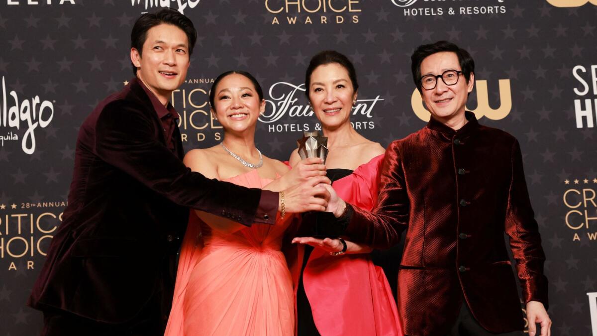 Harry Shum Jr., Stephanie Hsu, Michelle Yeoh, and Ke Huy Quan pose with the Best Picture award for 'Everything Everywhere All at Once'