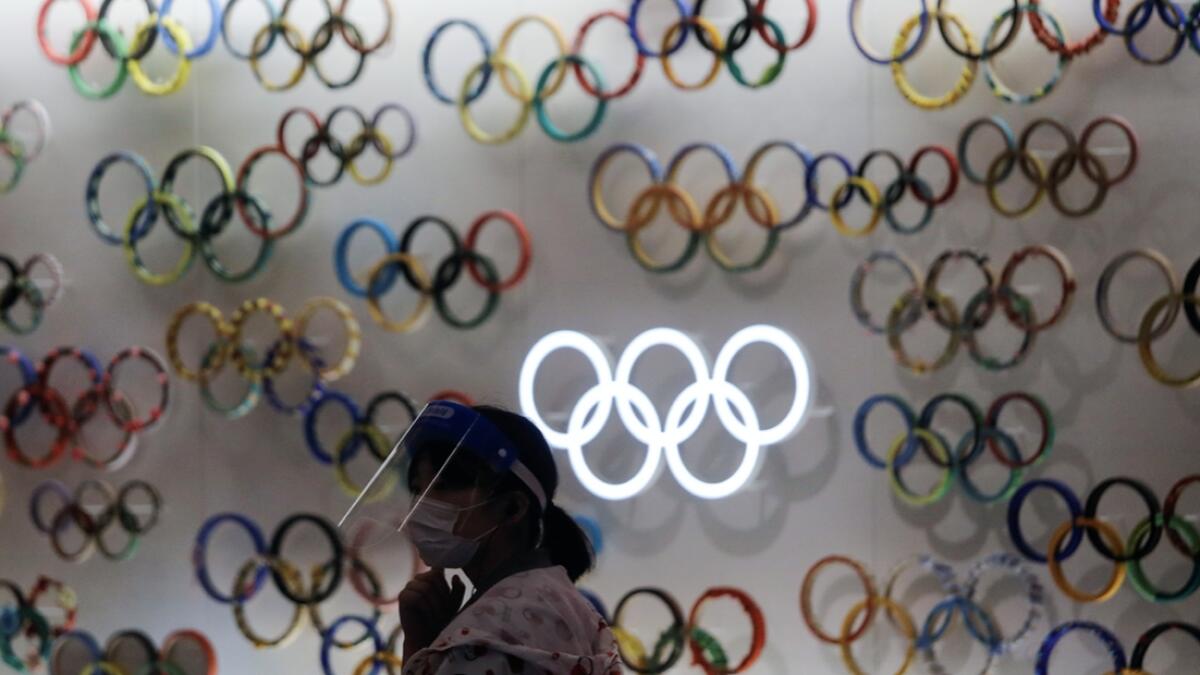 A woman wearing a protective face mask and face shield is seen inside Japan Olympics Museum, a day before the start of the one-year countdown to the Tokyo Olympics that have been postponed to 2021 due to the coronavirus disease (Covid-19) outbreak, in Tokyo, Japan. Photo: Reuters